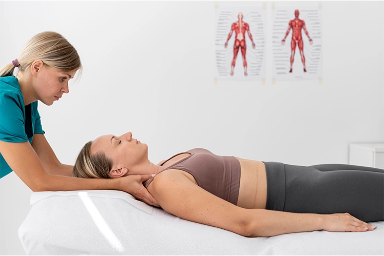 Therapist using knuckles along client’s neck muscles in detailed neuromuscular work