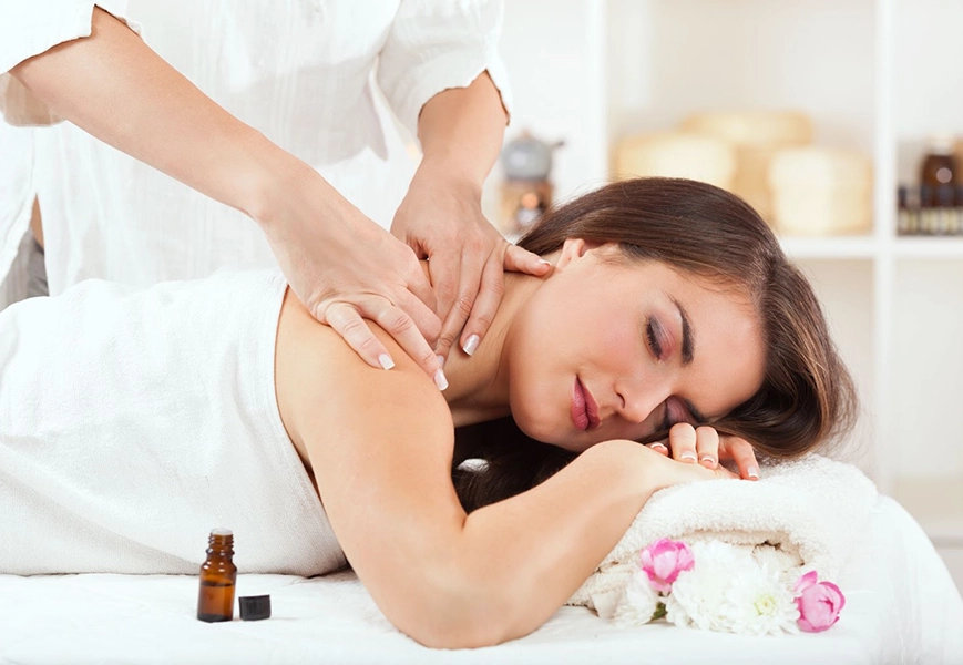 Woman Receiving Relaxing Massage with Aromatherapy in Spa Setting