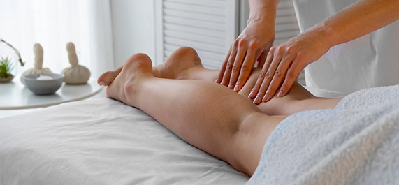 Massage Therapist Performing Swedish Massage in Downey CA on Client's Legs