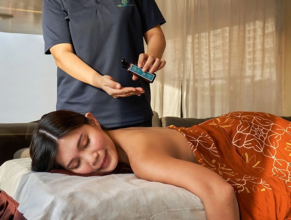 Massage Therapist Applying Oil for Relaxing Swedish Massage Session